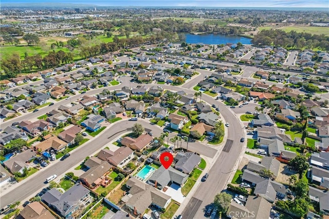 drone / aerial view with a water view and a residential view