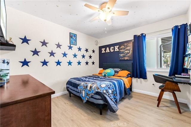 bedroom featuring a ceiling fan, light wood-type flooring, and baseboards