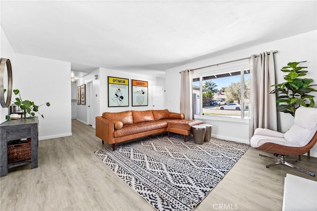 living room featuring baseboards and wood finished floors