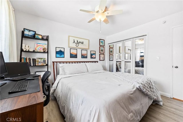 bedroom with french doors, wood finished floors, a ceiling fan, and baseboards