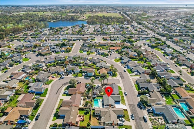 bird's eye view featuring a water view and a residential view