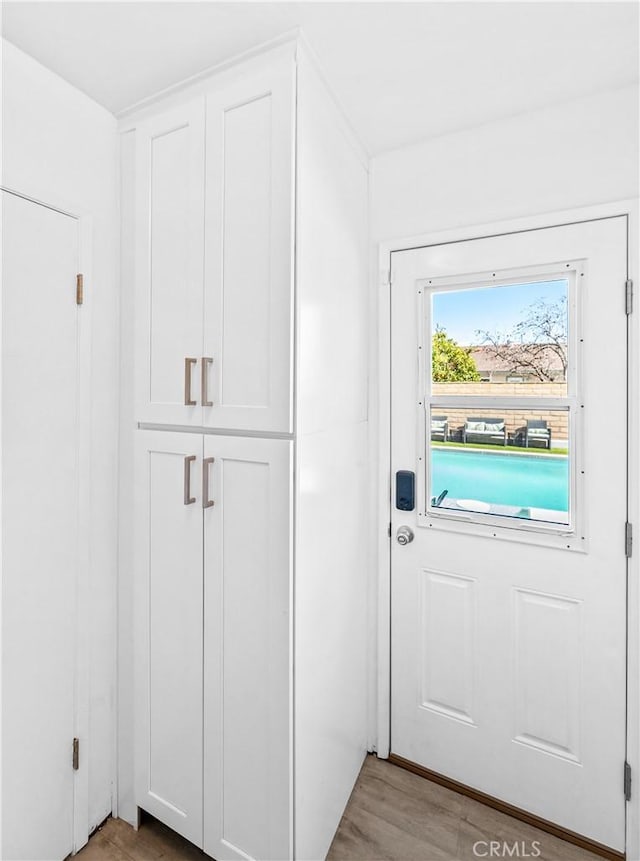 doorway with light wood finished floors