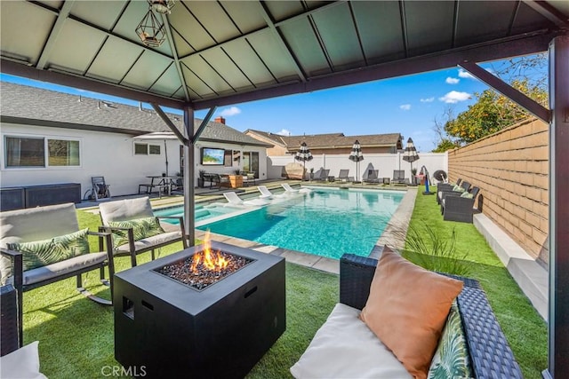 view of swimming pool featuring a fenced backyard, a gazebo, a fenced in pool, a patio area, and an outdoor living space with a fire pit