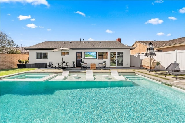 view of swimming pool with a fenced backyard, a fenced in pool, a patio, and an in ground hot tub