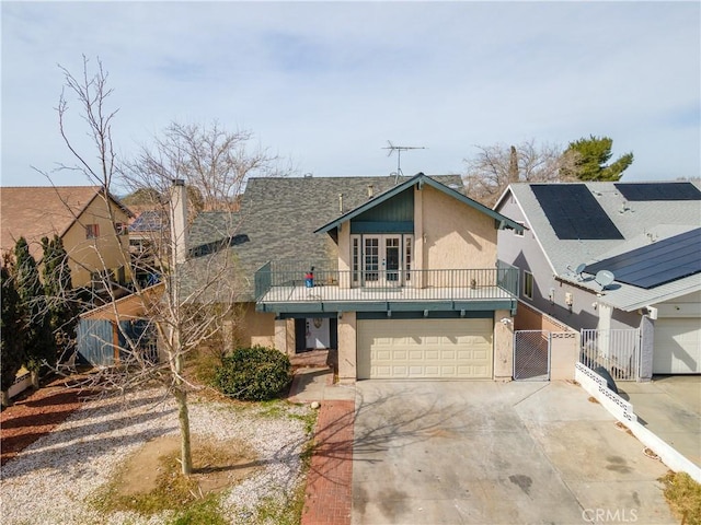 view of front facade featuring a garage, a gate, fence, and concrete driveway