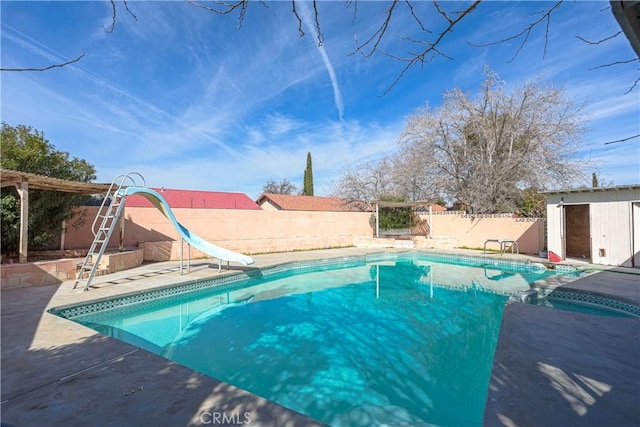 view of pool with a fenced in pool, a patio area, a water slide, and a fenced backyard