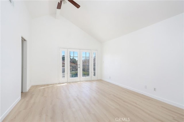 spare room with light wood-type flooring, baseboards, high vaulted ceiling, and ceiling fan