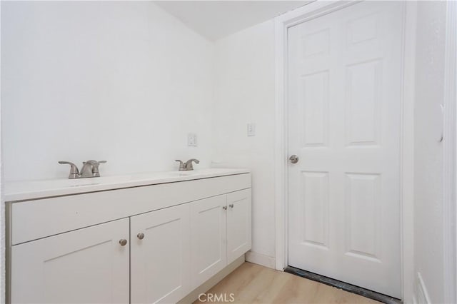 bathroom with a sink and wood finished floors