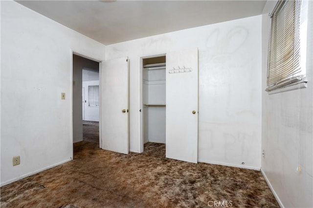 unfurnished bedroom with a closet and carpet