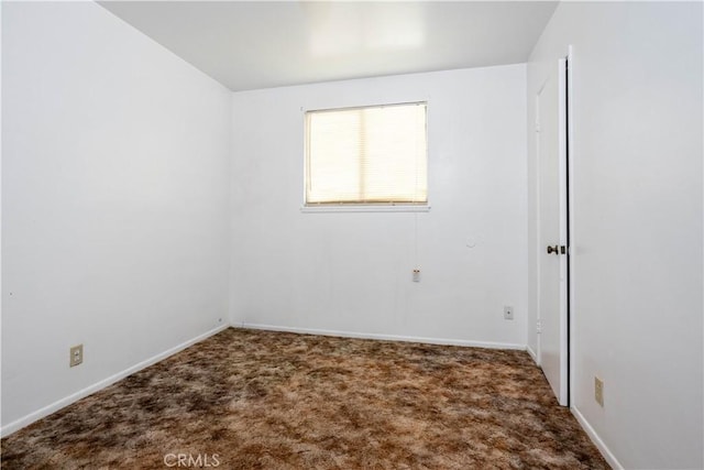 carpeted empty room with baseboards