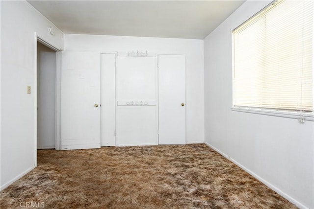 unfurnished bedroom featuring a closet and carpet