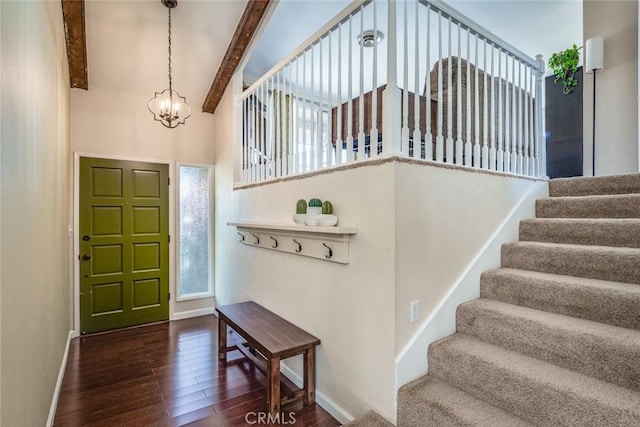 entrance foyer with a chandelier, baseboards, stairway, beamed ceiling, and dark wood finished floors