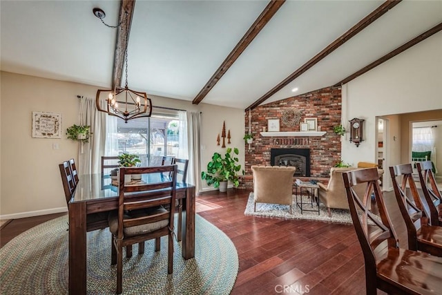 dining area with vaulted ceiling with beams, dark wood-type flooring, a fireplace, and baseboards