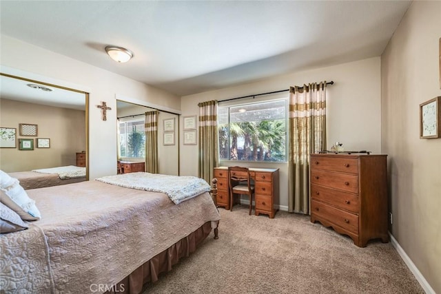 bedroom with light carpet and baseboards