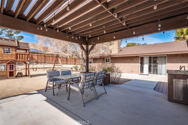 view of patio featuring fence and outdoor dining space