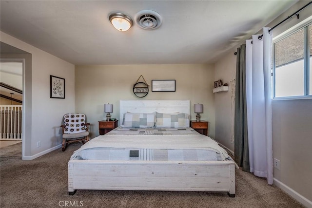 carpeted bedroom with visible vents and baseboards