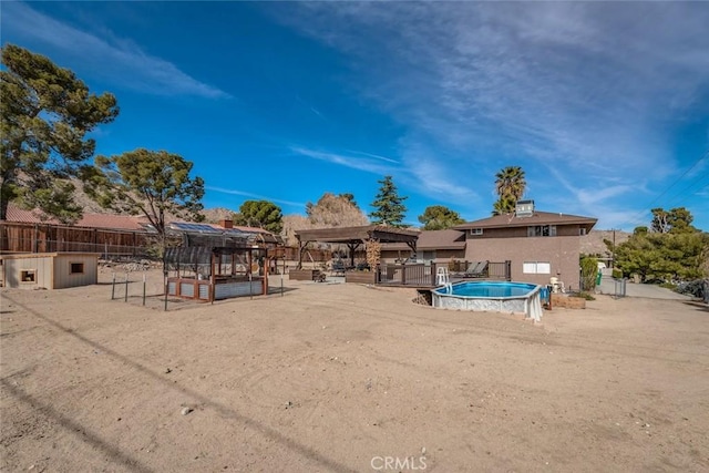 exterior space featuring fence, a fenced in pool, and a gazebo