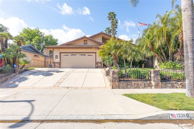 view of front of home featuring fence, a garage, and driveway