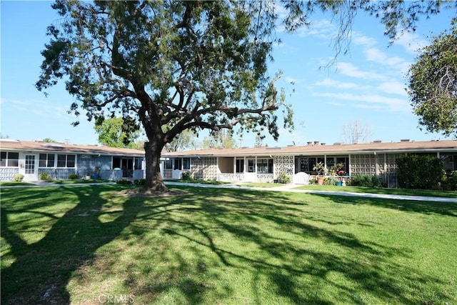 back of house with a lawn