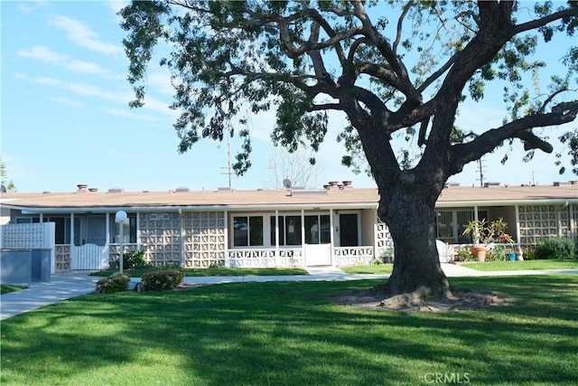 ranch-style home featuring a front yard and a sunroom