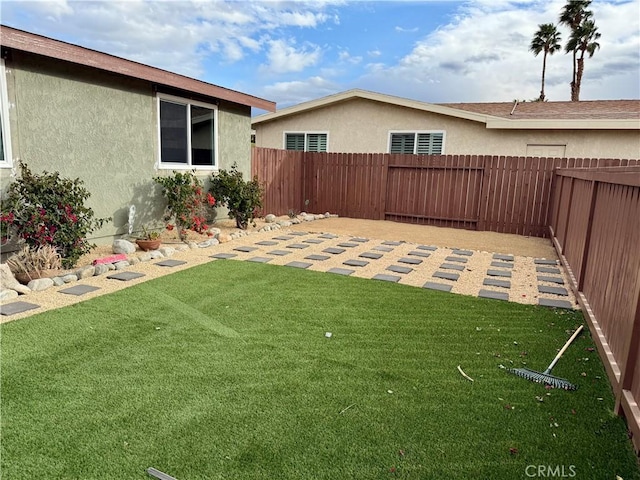 view of yard with a patio and a fenced backyard