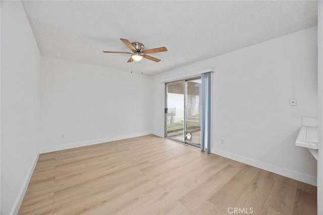 unfurnished room with a ceiling fan, baseboards, a textured ceiling, and light wood finished floors