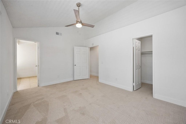 unfurnished bedroom featuring lofted ceiling, carpet flooring, and baseboards