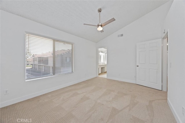 carpeted empty room with high vaulted ceiling, ceiling fan, visible vents, and baseboards