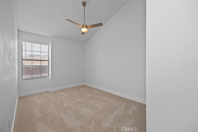 unfurnished room with carpet floors, lofted ceiling, ceiling fan, a textured ceiling, and baseboards