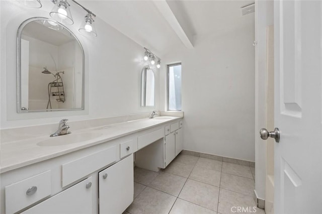 full bathroom featuring double vanity, tile patterned flooring, baseboards, and a sink