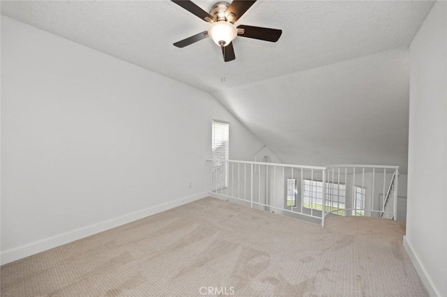 bonus room featuring lofted ceiling, carpet flooring, and baseboards