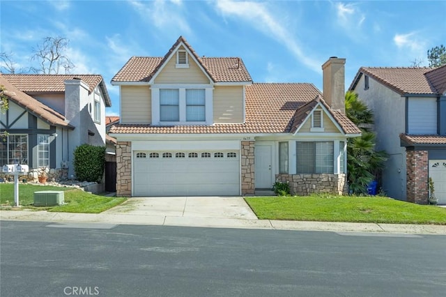 view of front of property featuring an attached garage, a tiled roof, stone siding, and driveway