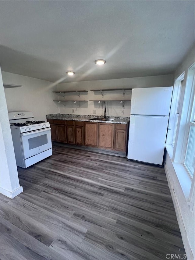 kitchen with white appliances, brown cabinets, dark wood-type flooring, light countertops, and open shelves