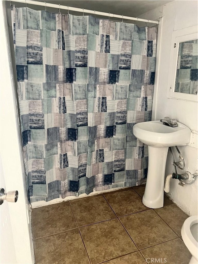 bathroom featuring a shower with shower curtain and tile patterned floors