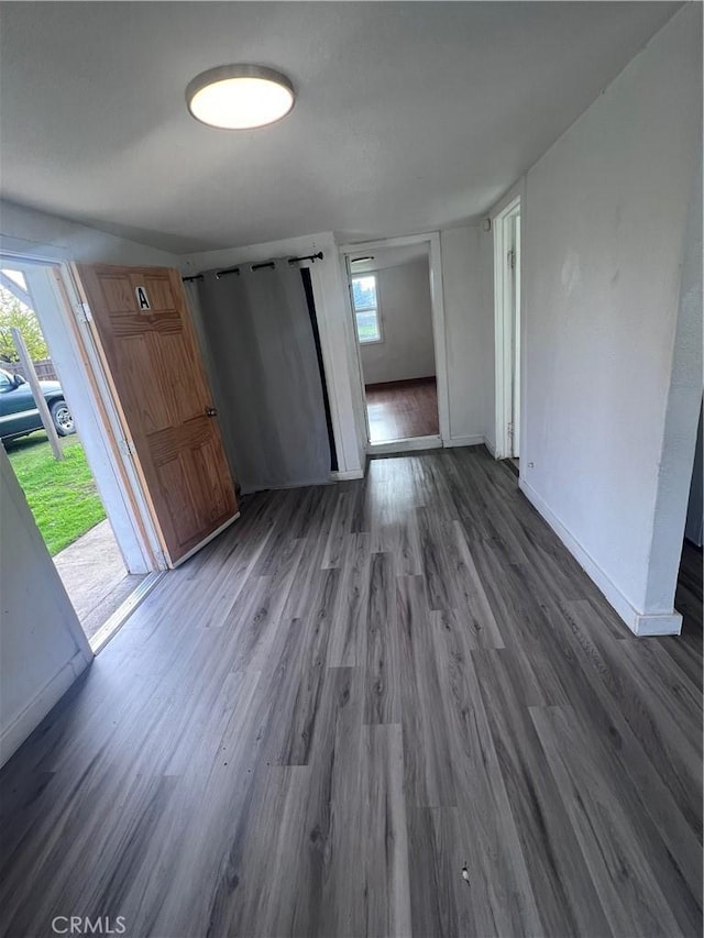 interior space with wood finished floors and baseboards