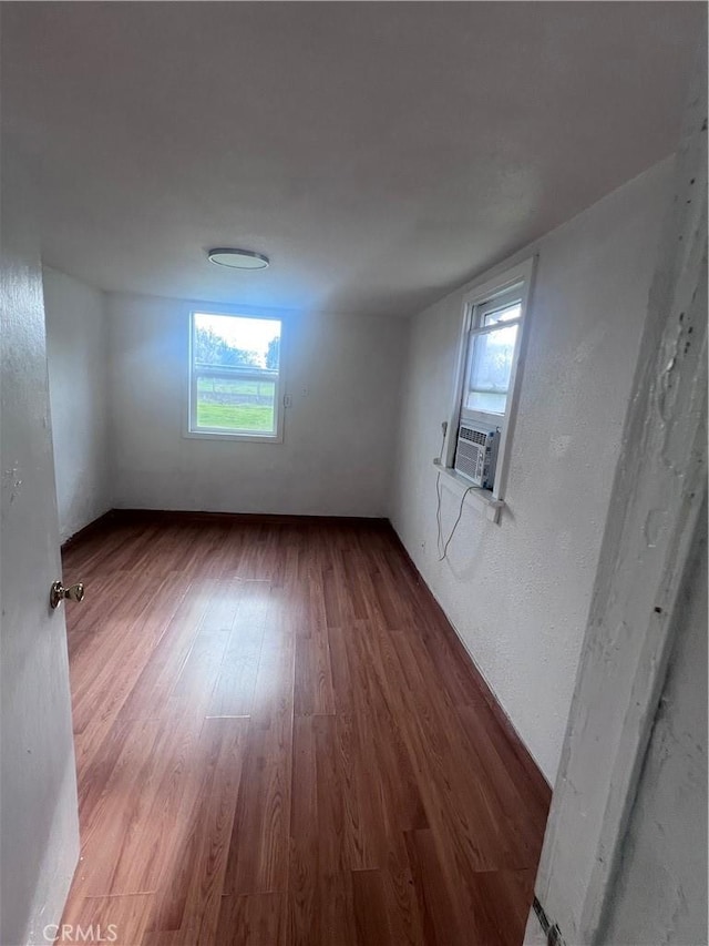 basement with cooling unit and wood finished floors