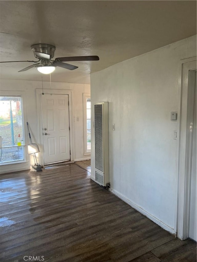 entrance foyer with baseboards, a heating unit, dark wood finished floors, and a ceiling fan