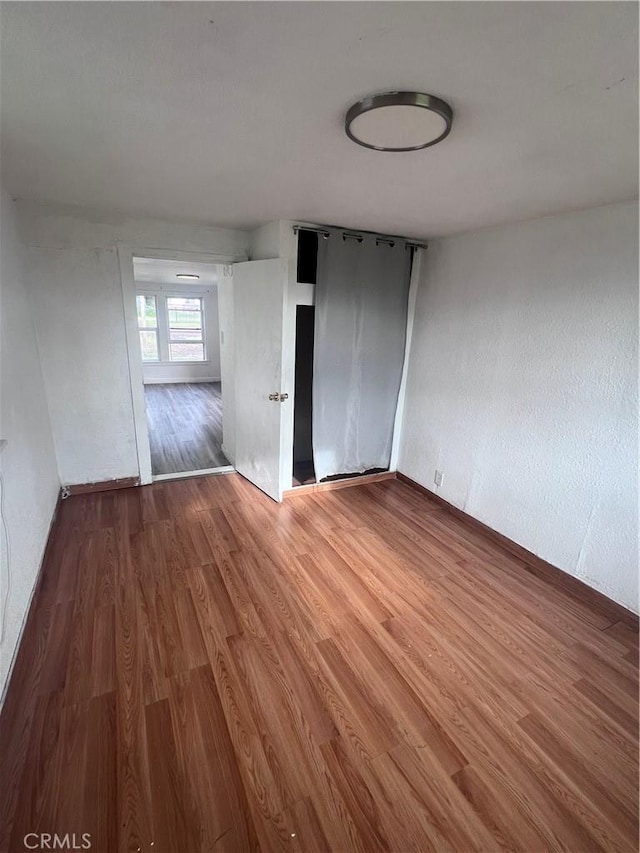 spare room featuring wood finished floors