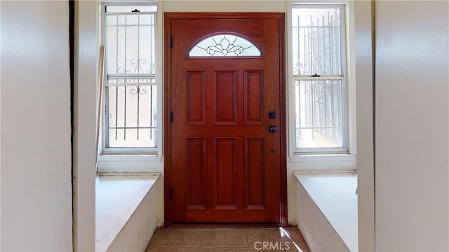 foyer featuring a wealth of natural light and light tile patterned flooring