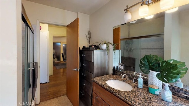 bathroom featuring a stall shower, tile patterned floors, and vanity