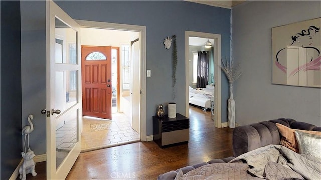 foyer entrance featuring baseboards and wood finished floors