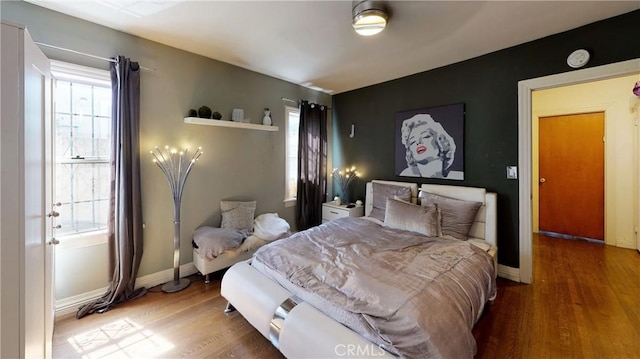 bedroom featuring baseboards and wood finished floors