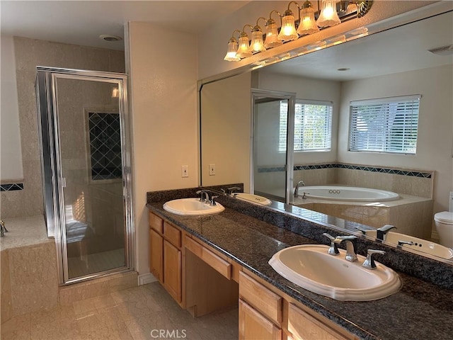 bathroom with a garden tub, visible vents, a sink, and a stall shower