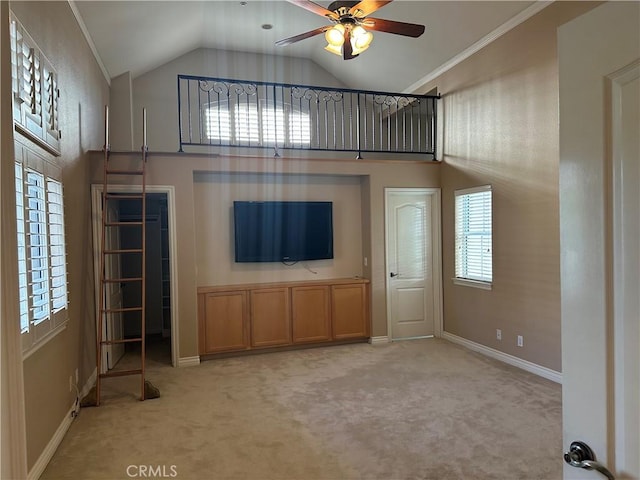 unfurnished living room featuring a wealth of natural light and light colored carpet