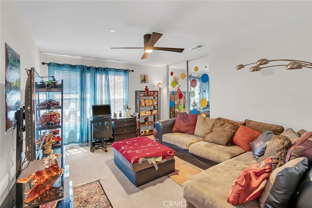 living area featuring ceiling fan, carpet floors, and visible vents