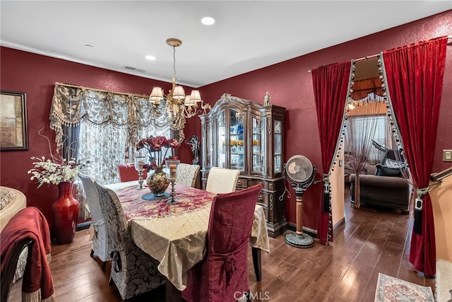 dining room featuring a chandelier, a textured wall, recessed lighting, visible vents, and hardwood / wood-style floors