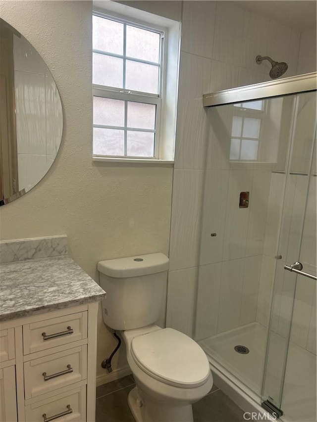 full bath with toilet, a shower stall, and vanity