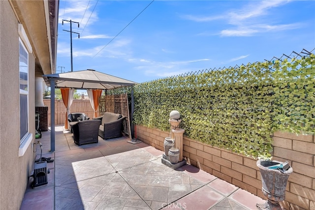 view of patio / terrace with a fenced backyard and a gazebo