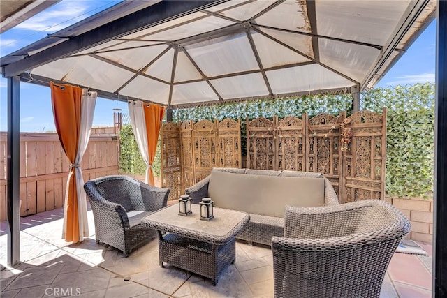 view of patio / terrace with an outdoor hangout area, a gazebo, and fence