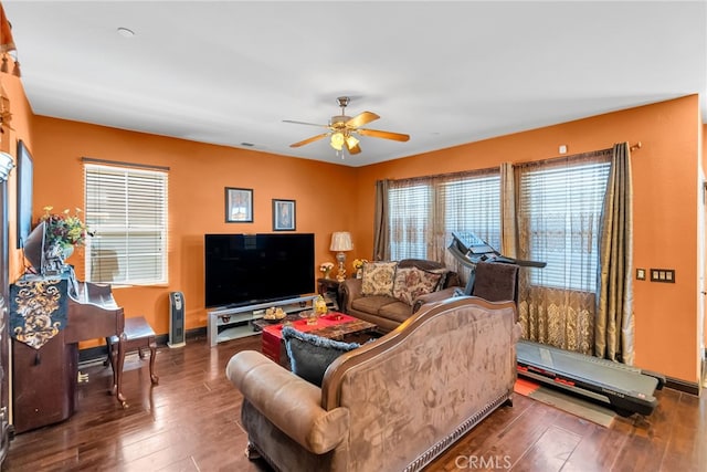 living room with visible vents, ceiling fan, baseboards, and hardwood / wood-style flooring